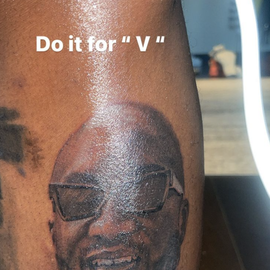 Virgil Abloh portrait tattoo located on the upper arm.